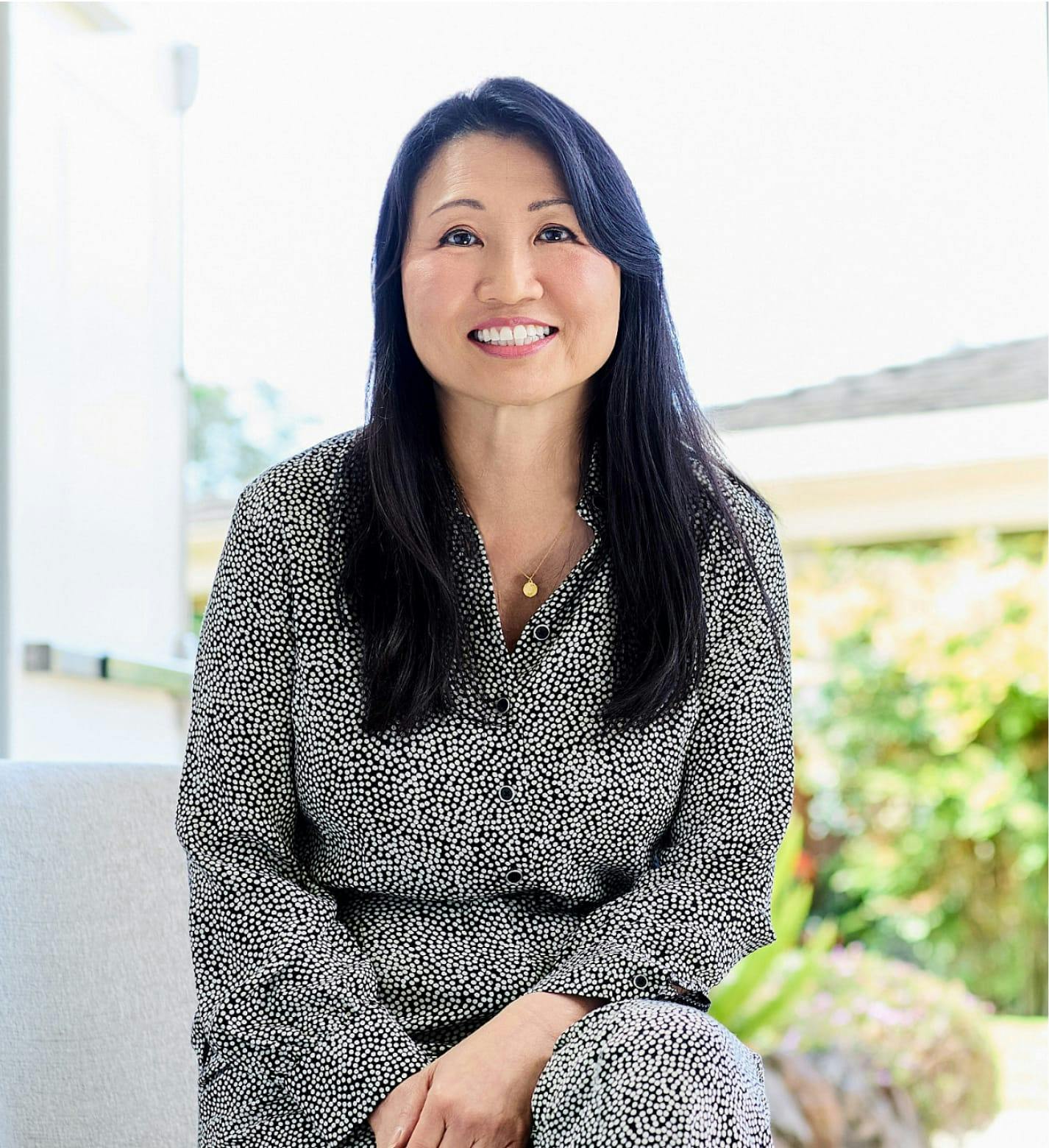 Picture of Jacqueline sitting outside smiling