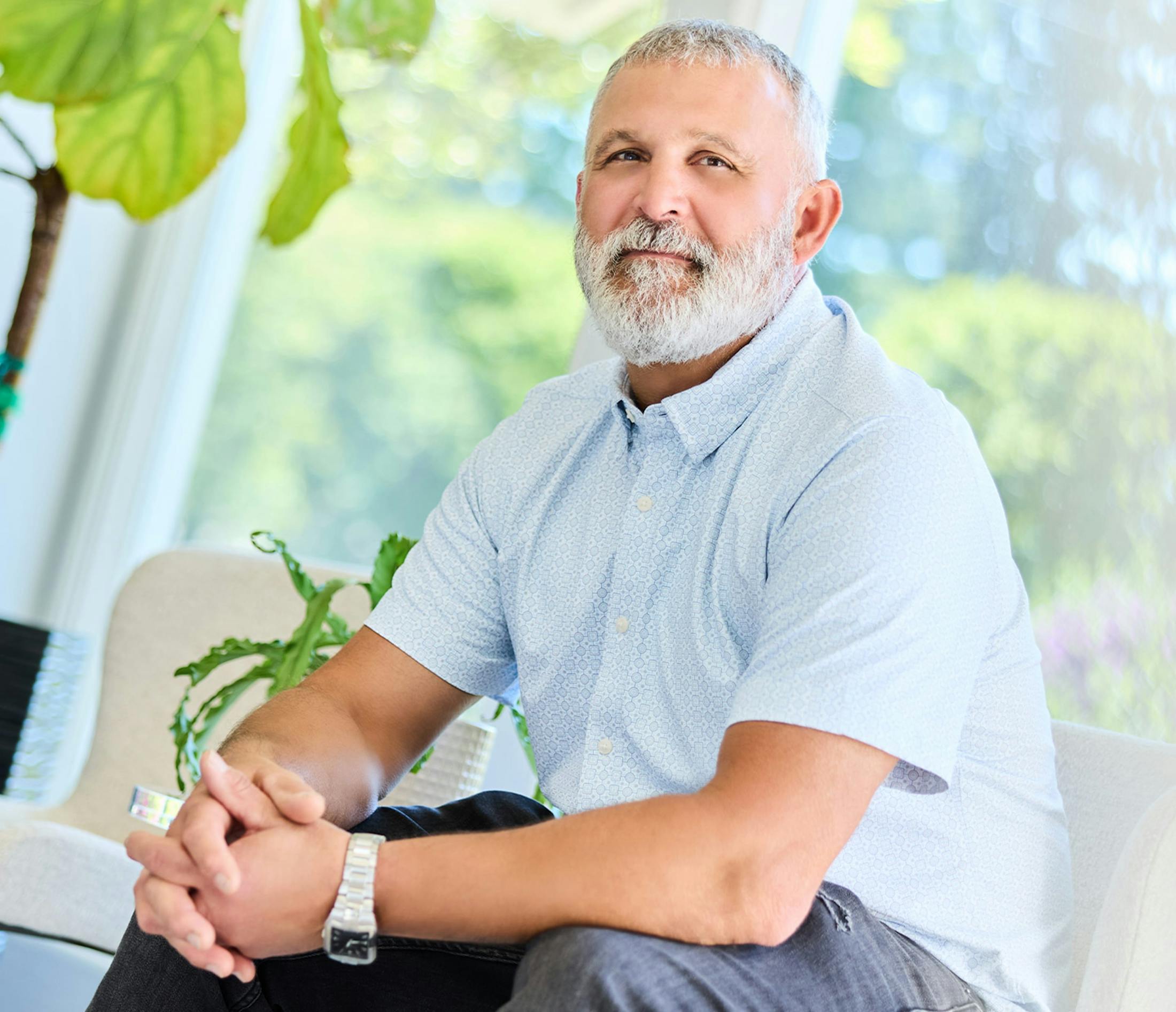Man smiling while sitting in a chair