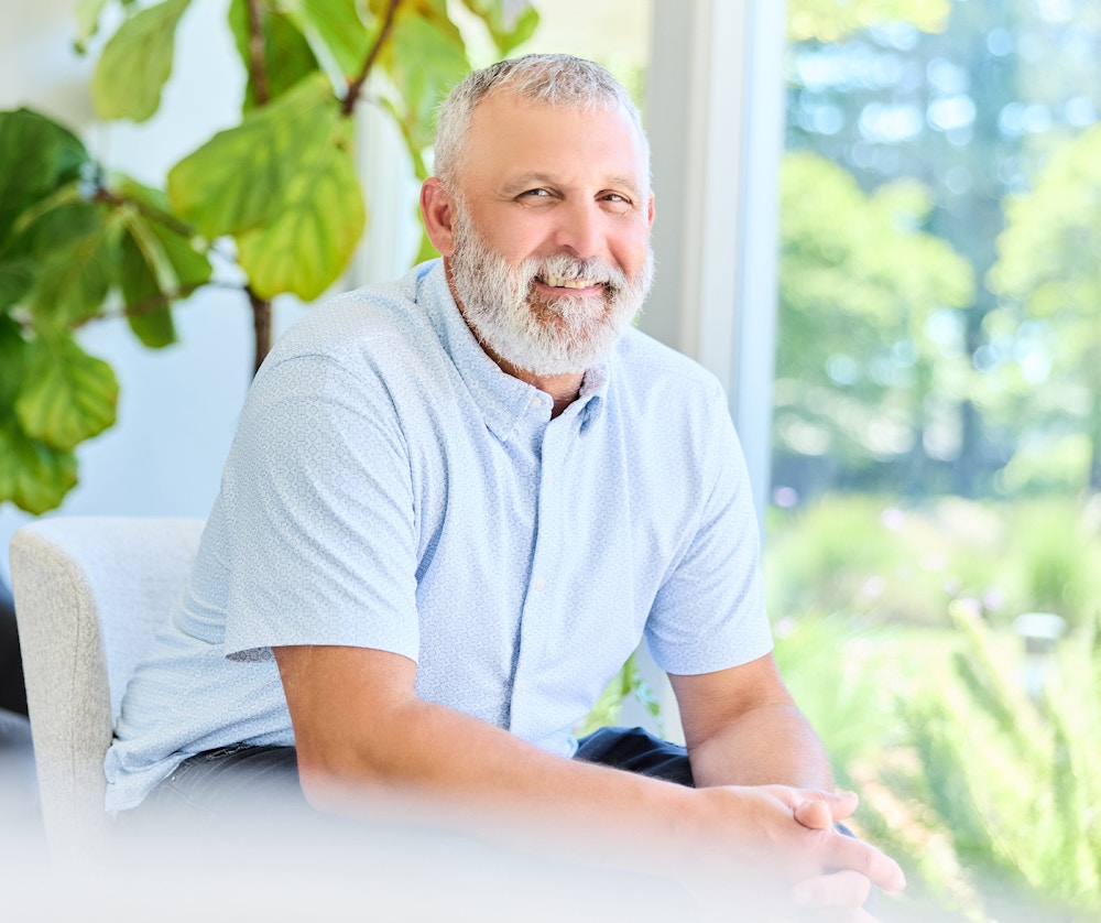 older man sitting and smiling