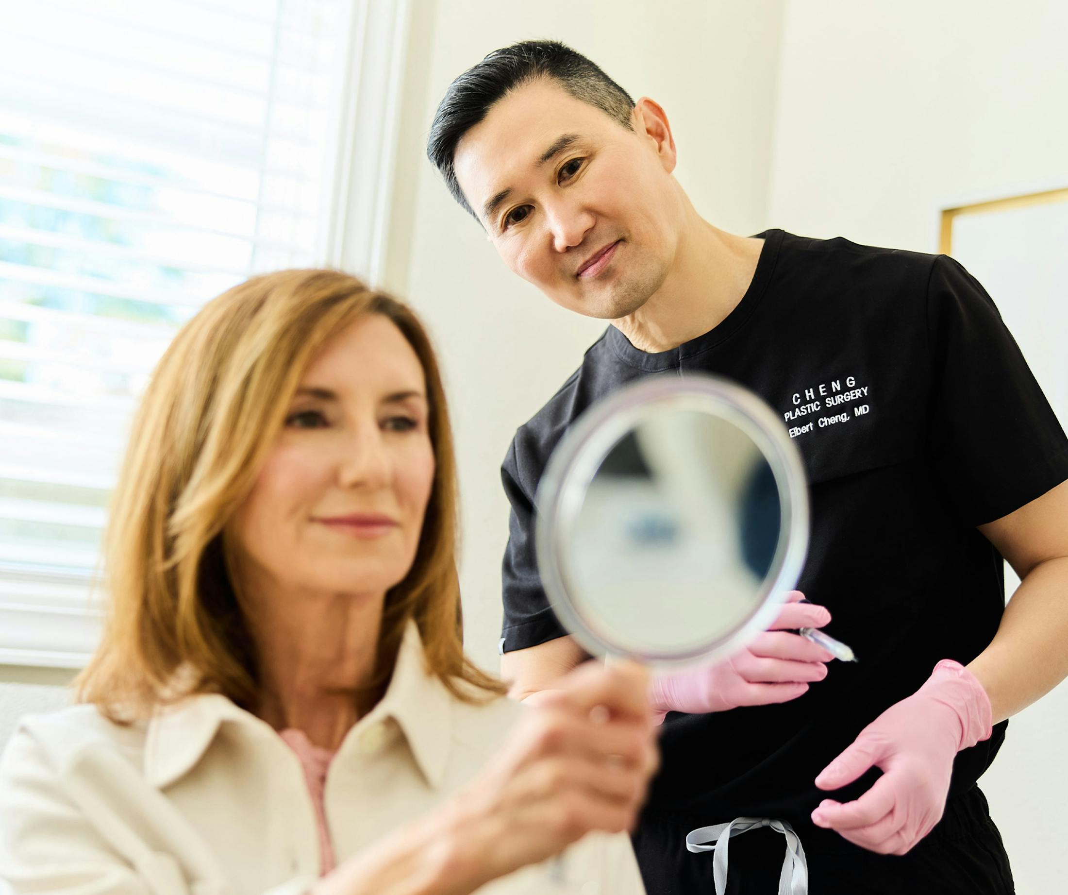 doctor with patient looking in mirror