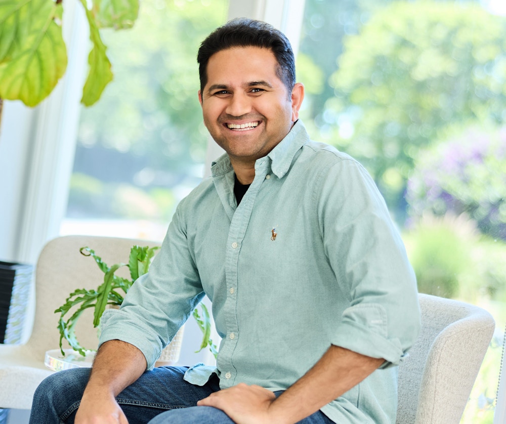 Man smiling while sitting in a chair