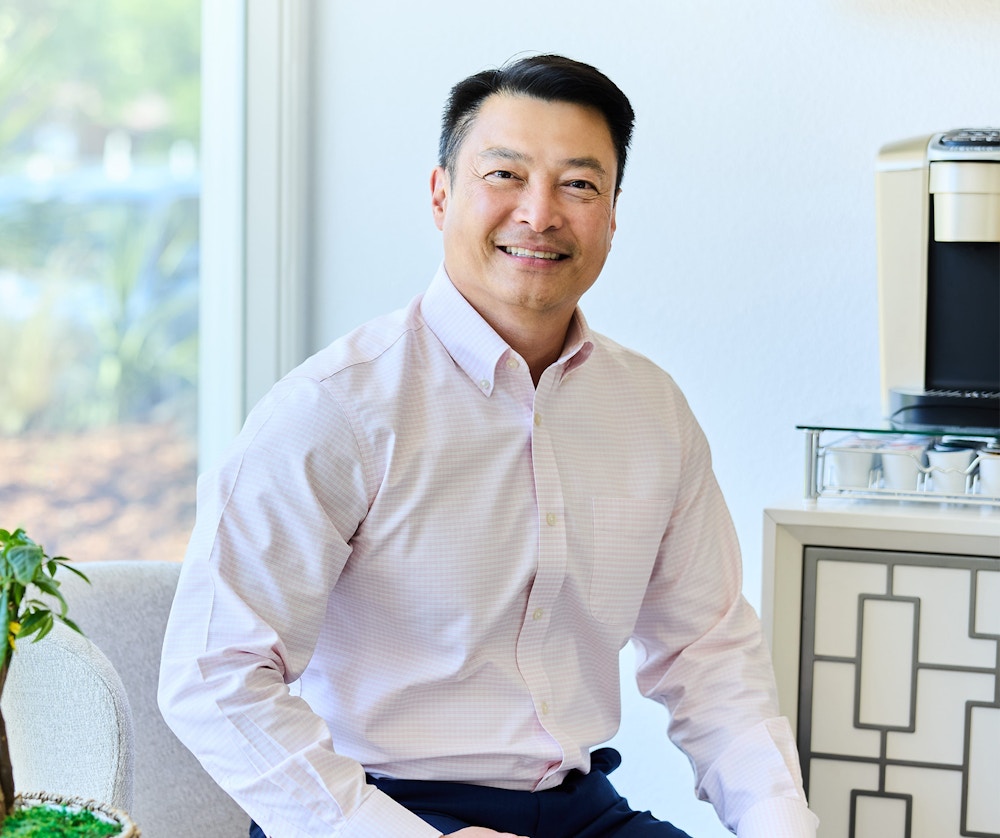 Man smiling while sitting in a chair