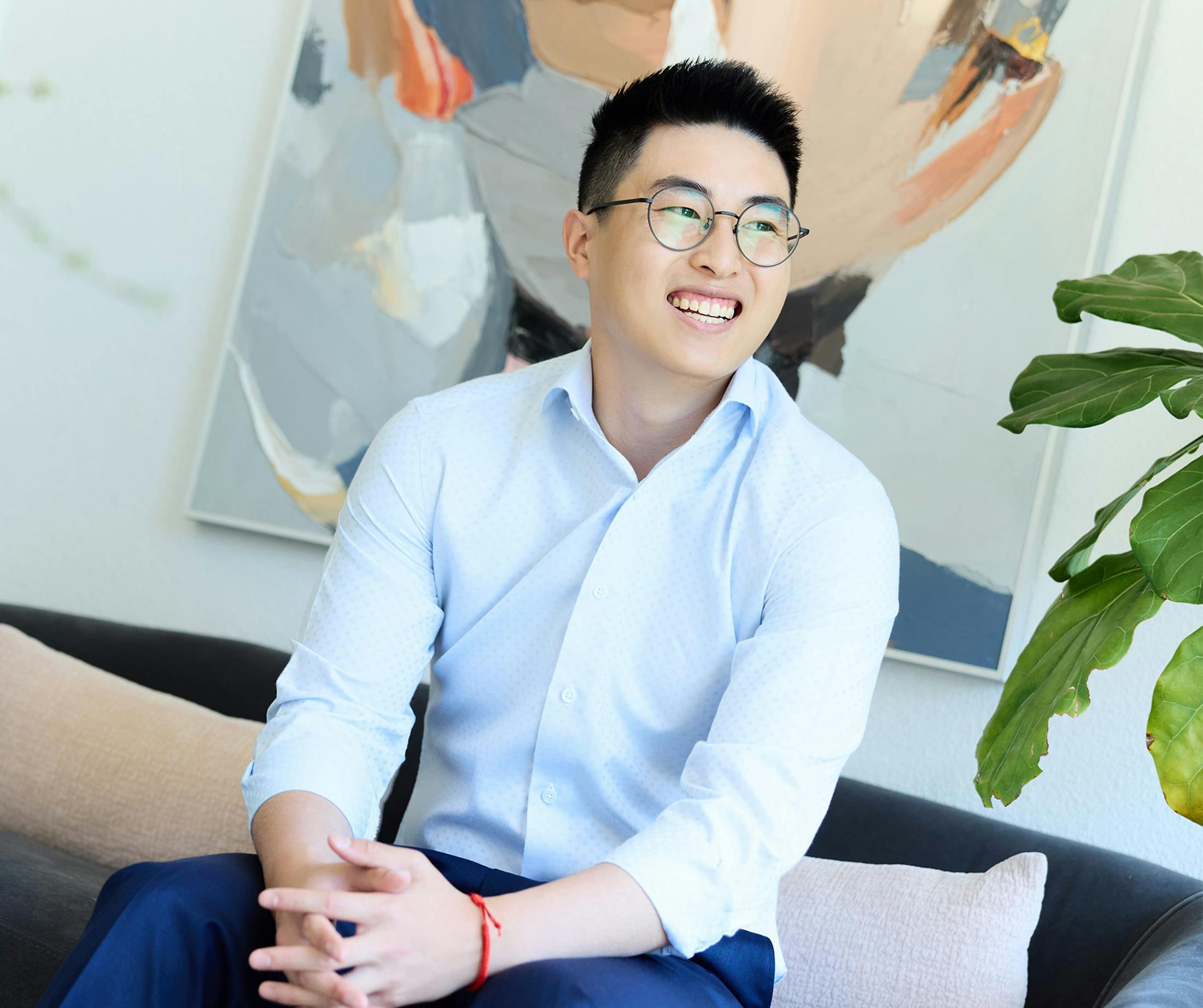 man smiling sitting on couch