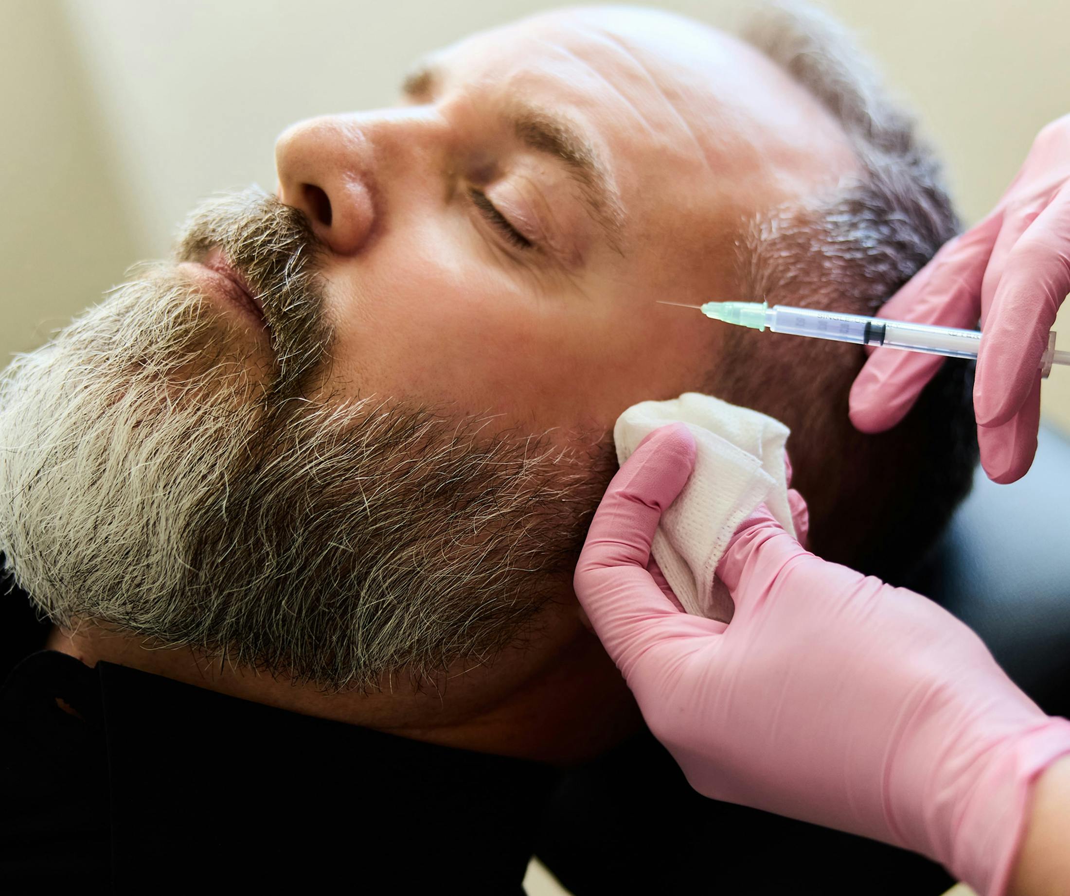 man receiving injections in face
