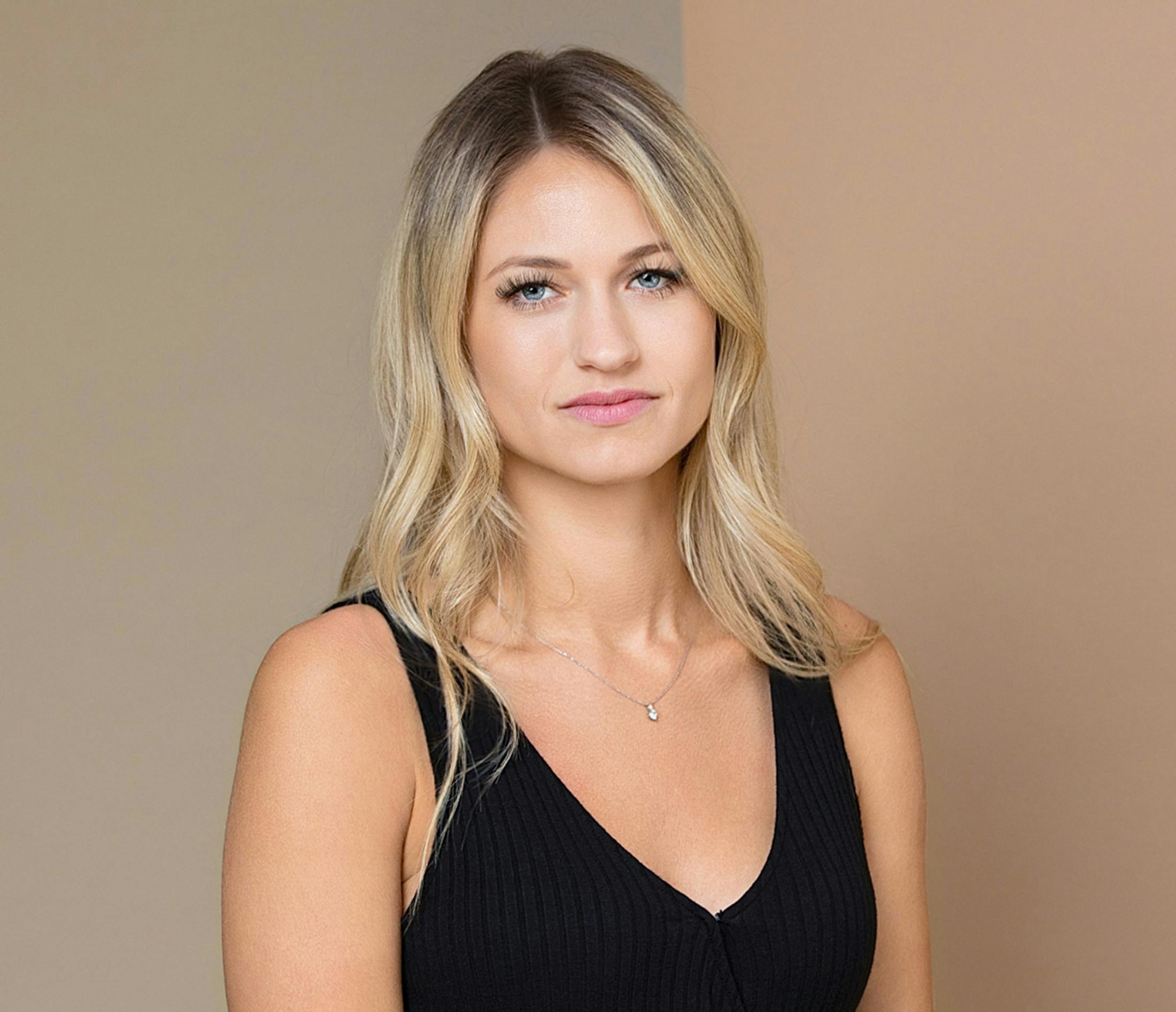 woman with blonde hair wearing a black shirt