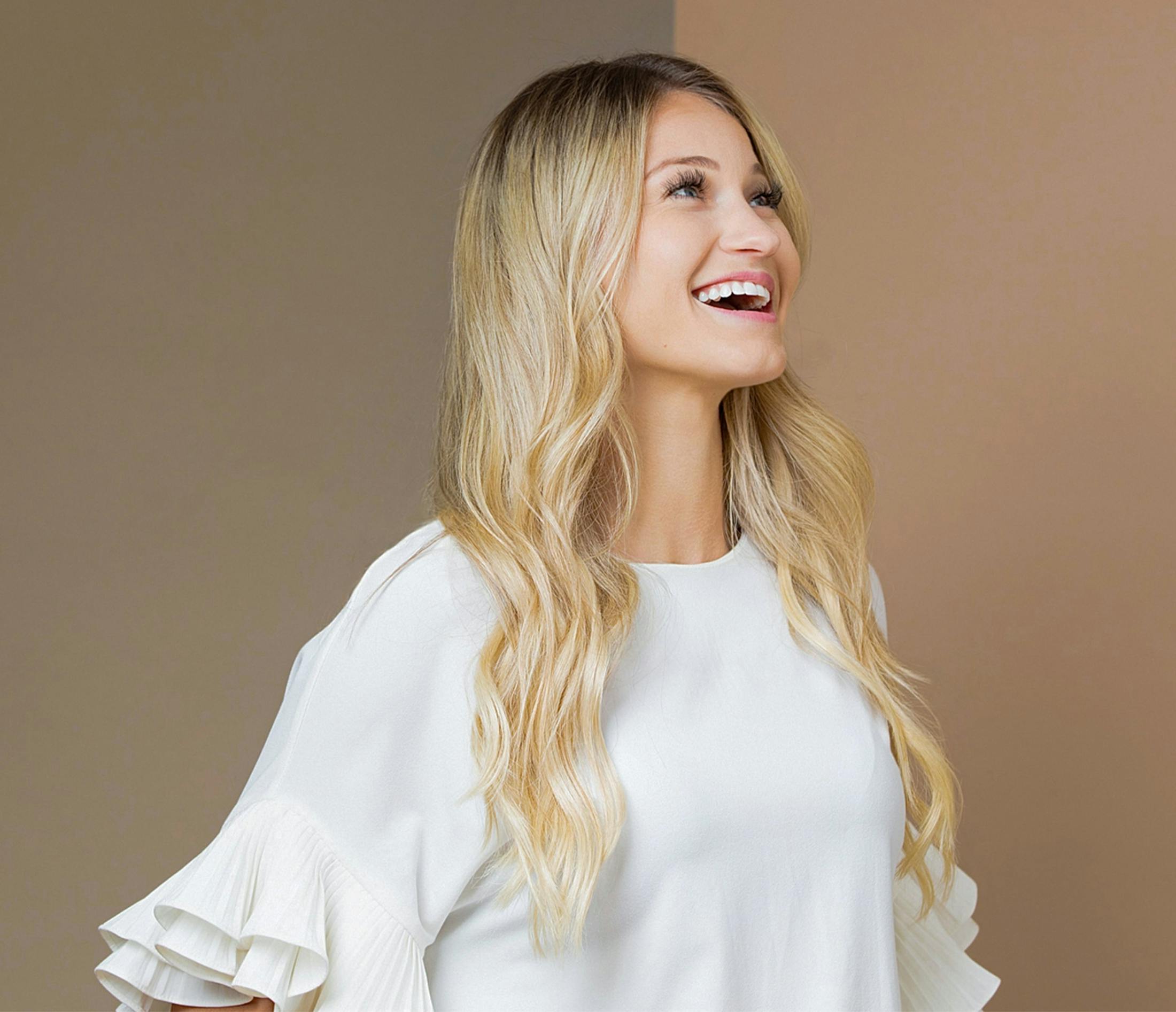 woman with blonde hair wearing a white shirt