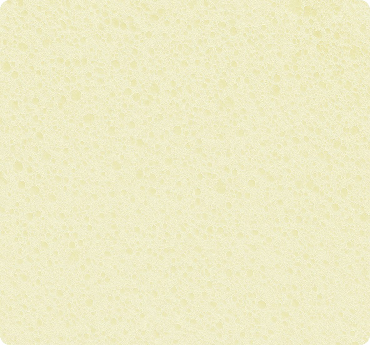 Superficie porosa e spugnosa di colore giallo chiaro con numerosi buchi di varie dimensioni.