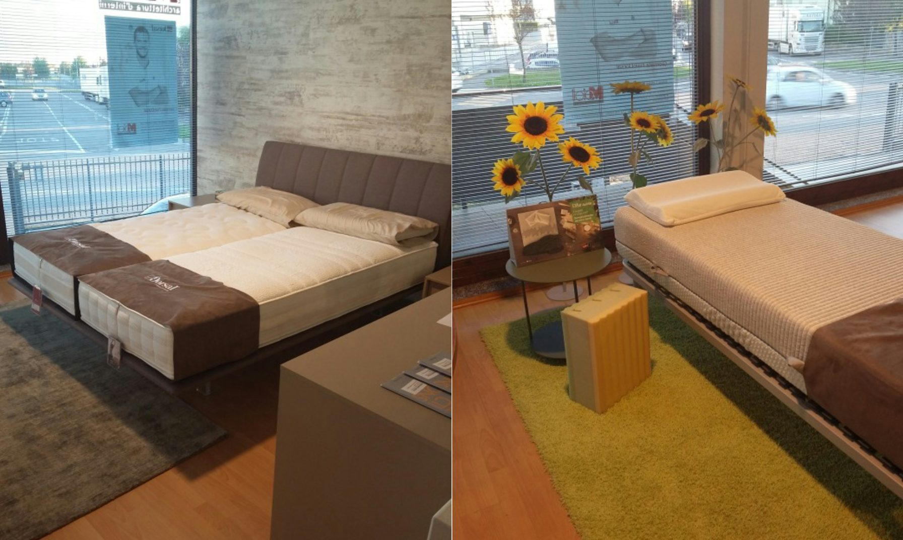 Letti matrimoniali con testata imbottita e materassi in esposizione in showroom con ampie finestre e arredi moderni.