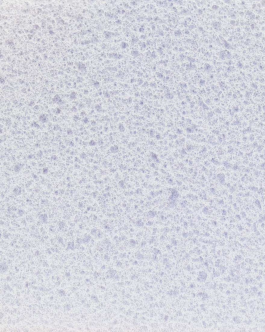 Superficie bianca con texture a bolle sottili e irregolari, dall'aspetto poroso.