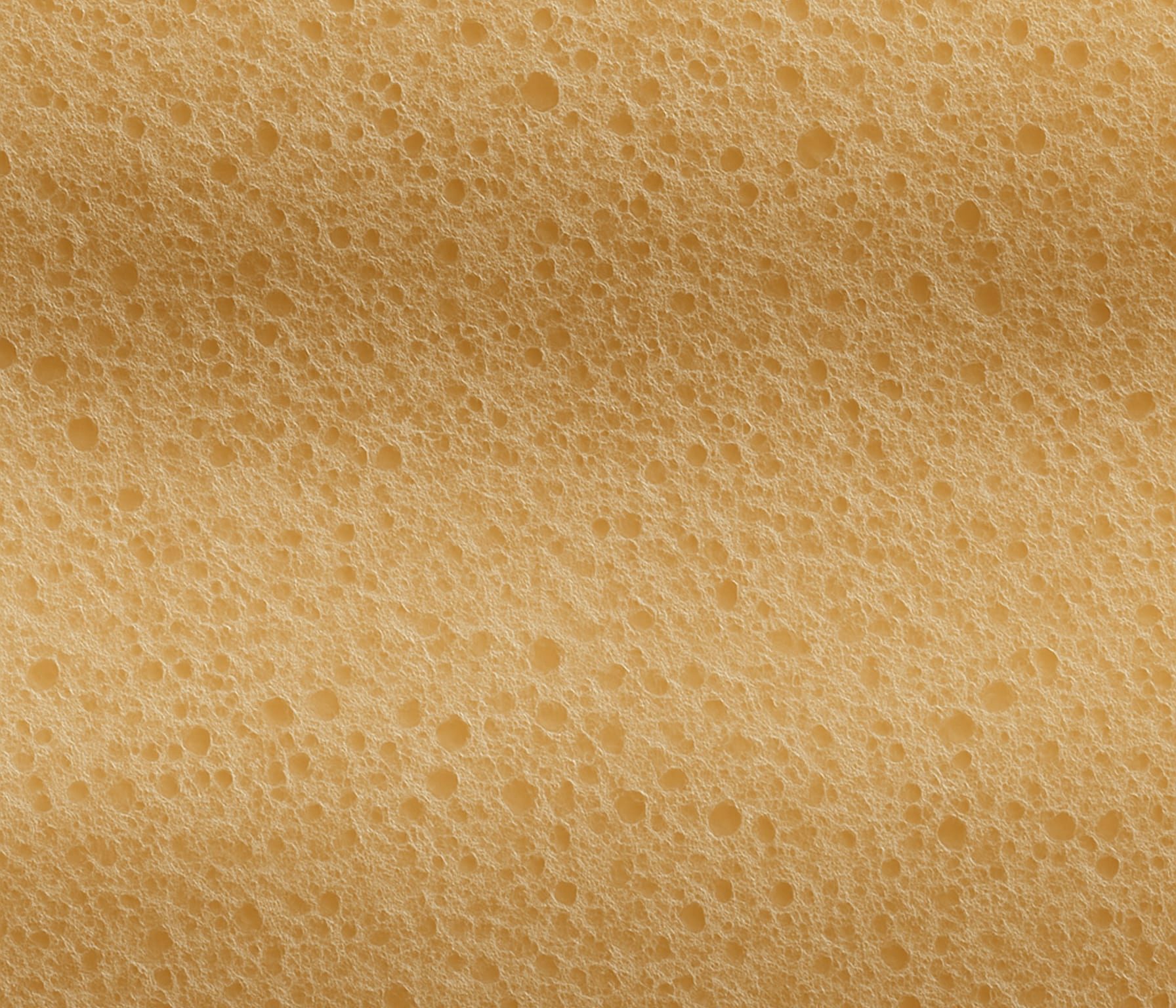 Superficie arancione con pattern a bolle irregolari di diverse dimensioni, simile a una spugna o schiuma.