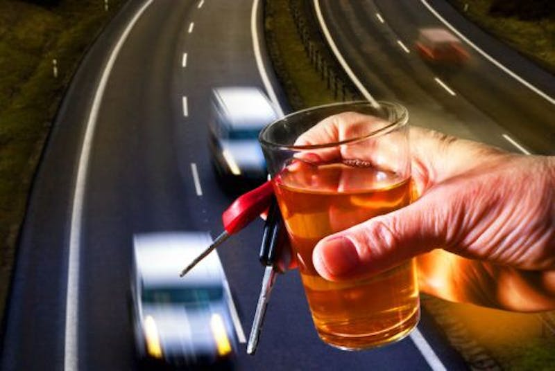 person holding a drink and car keys