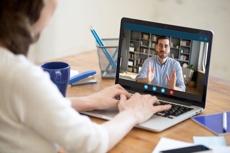 woman video conferencing on a laptop.