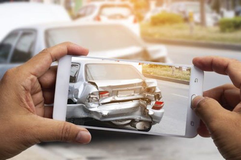 Person taking a picture of a car accident