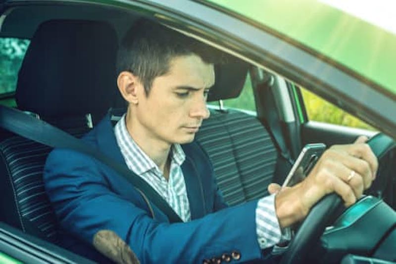 Man texting and driving
