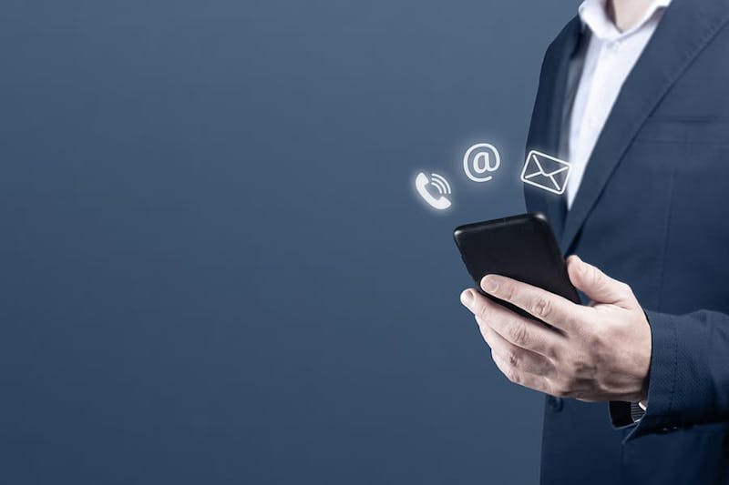 man in a suit holding a cell phone
