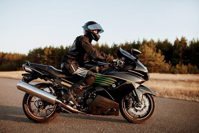 all black motorcyclist