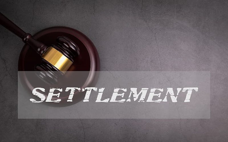 The word SETTLEMENT imposed over a judge's gavel.