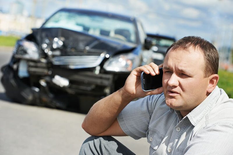 Person on the phone after a car accident