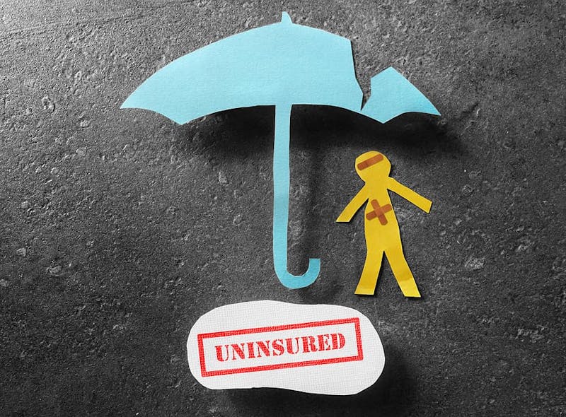paper cutouts of an umbrella and injured person