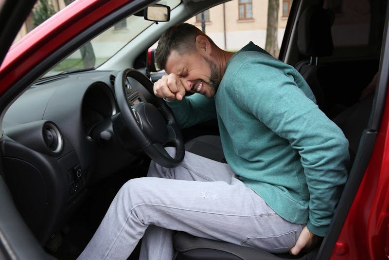 Person having back pain after an accident