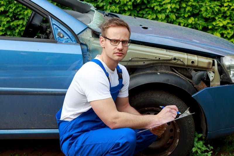 Person looking at their car after an accident