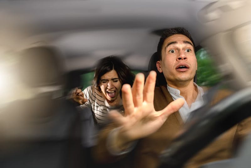 man and woman getting in car crash