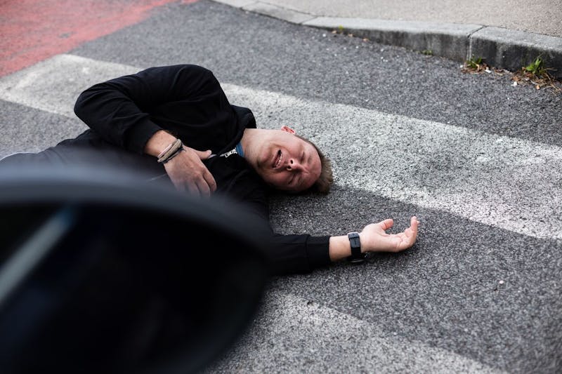 Man laying in a crosswalk
