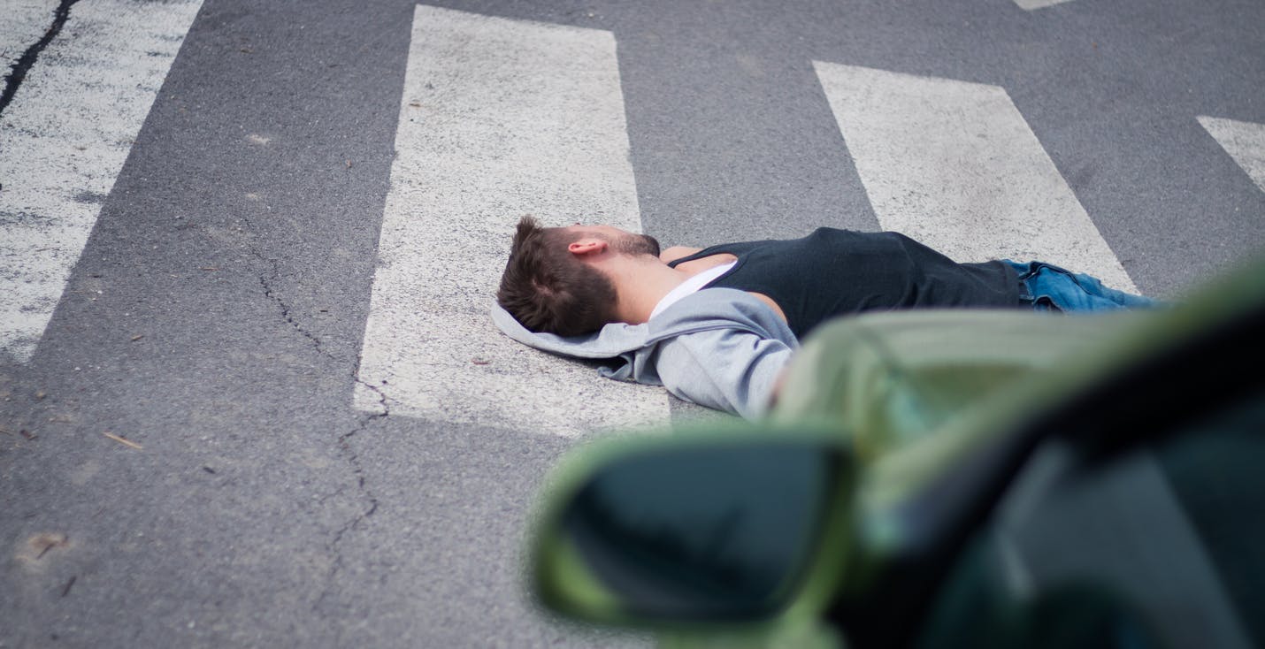Man laying in a crosswalk
