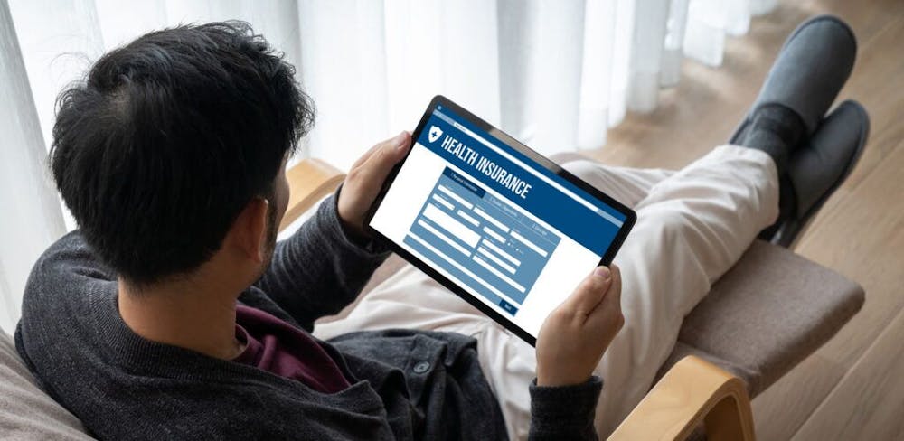 Man sitting and shopping on his tablet