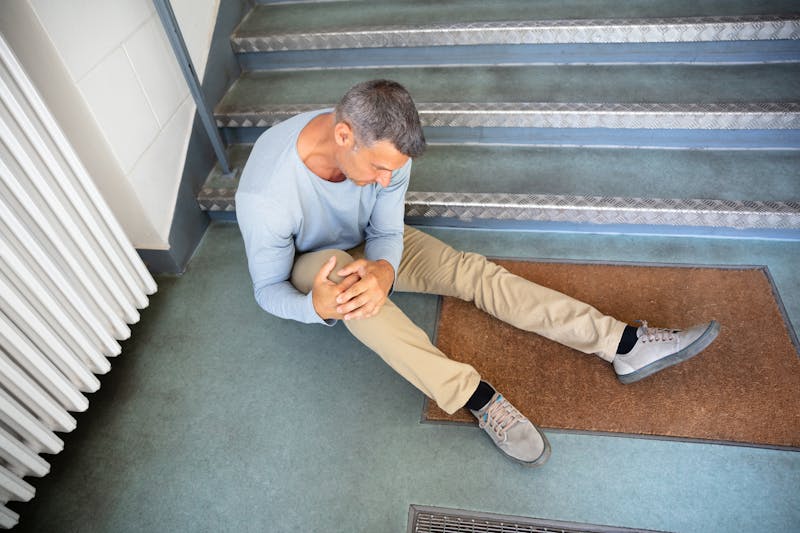 A man who has fallen on the stairs