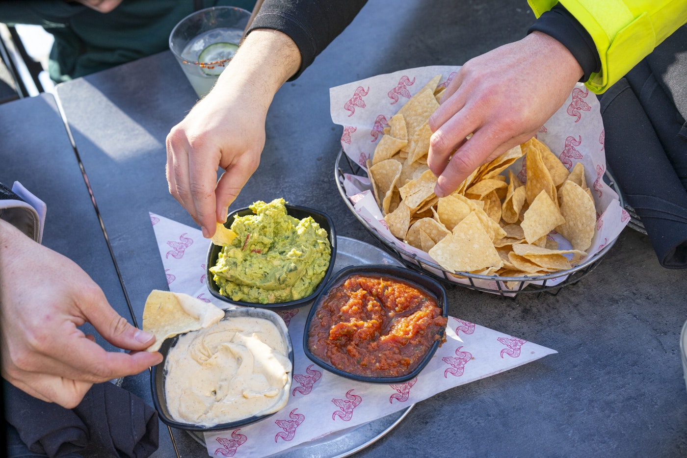 People Eating Chips Guac and Salsa