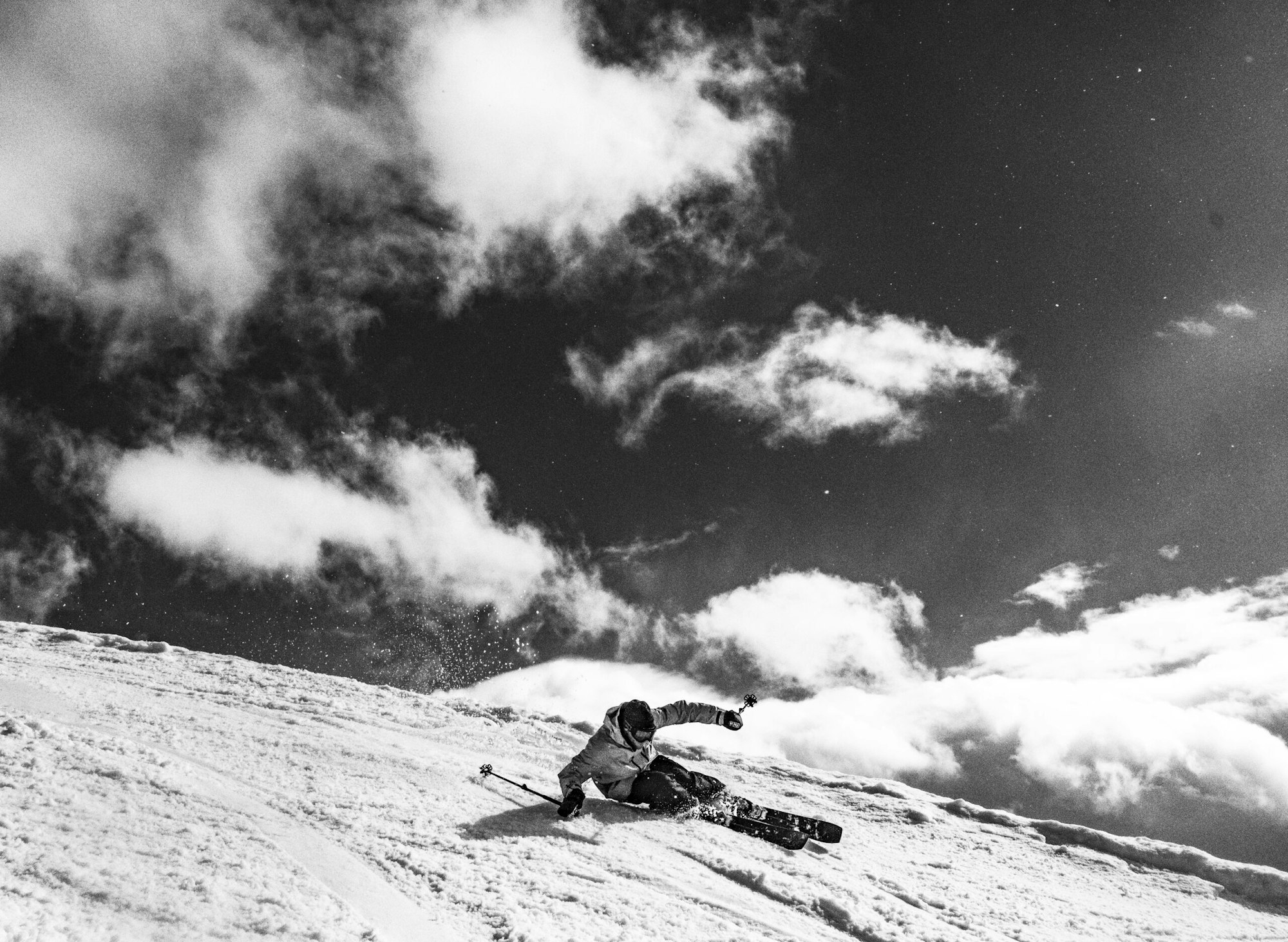 Skier carves a deep turn on a snowy mountainside