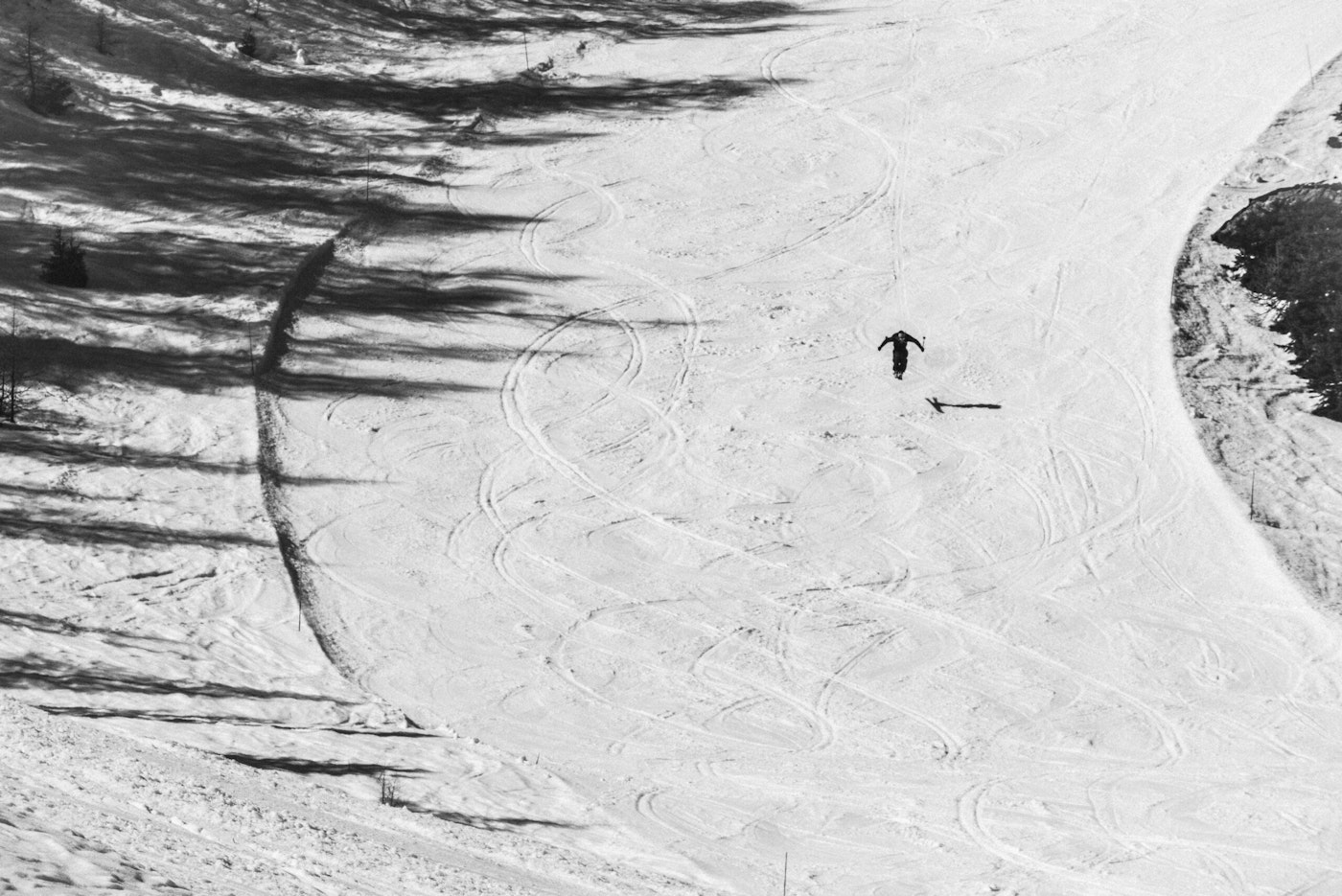 Skier airborne on a wide open slope