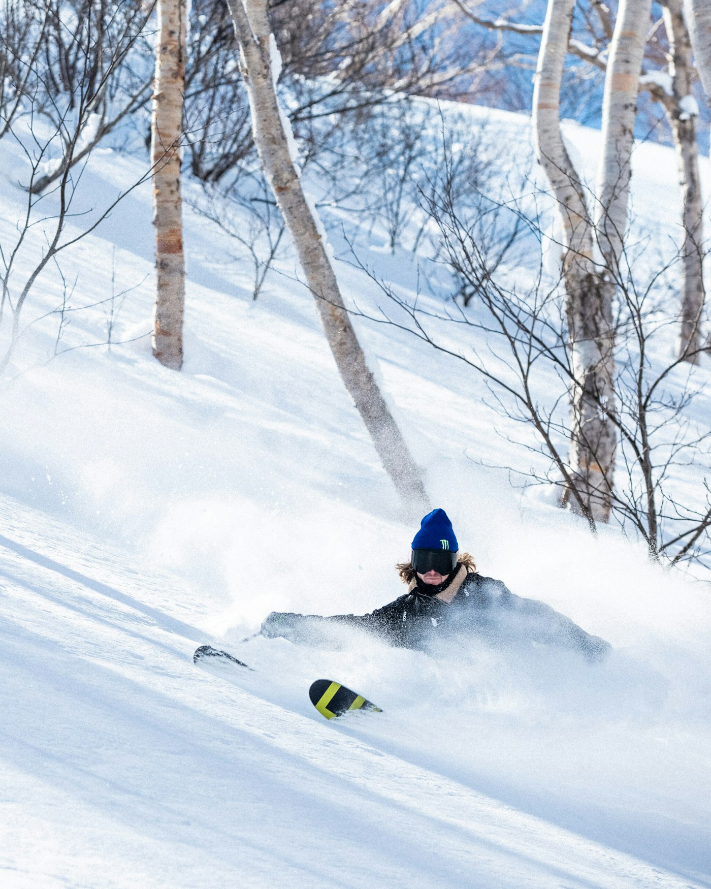 Skier James Woodsy turning in deep snow in the forest