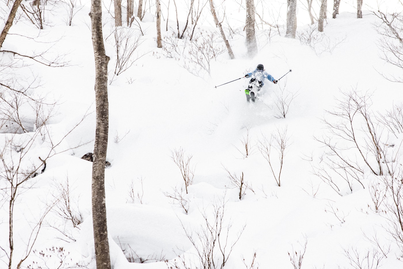 Skier Robert Ruud skiing through deep snow in the woods