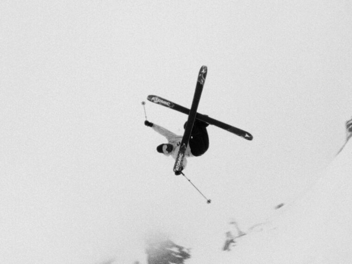 Skier crosses skis in the air spinning