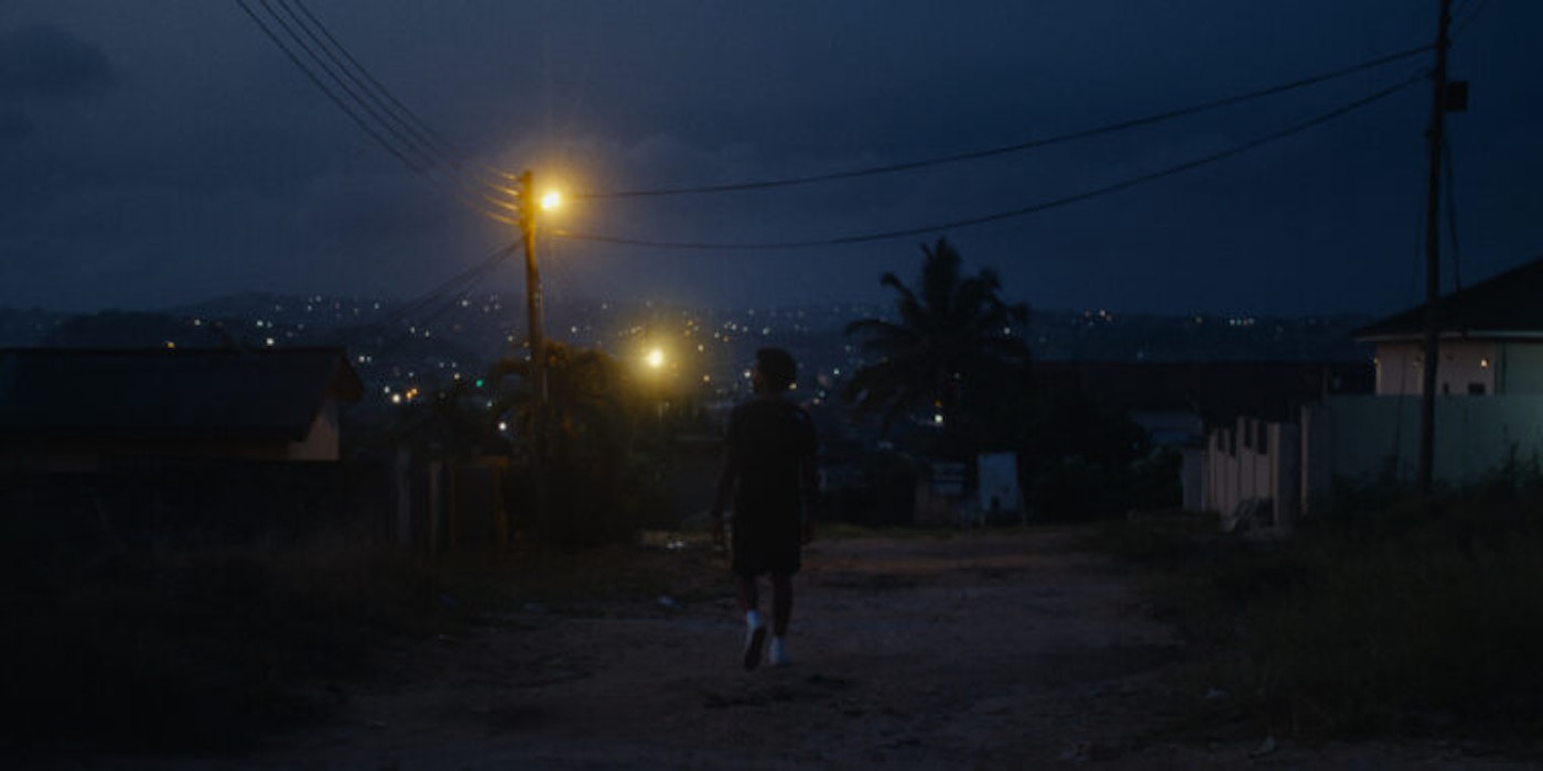 Dennis Ranalter walks down a dark city street at night