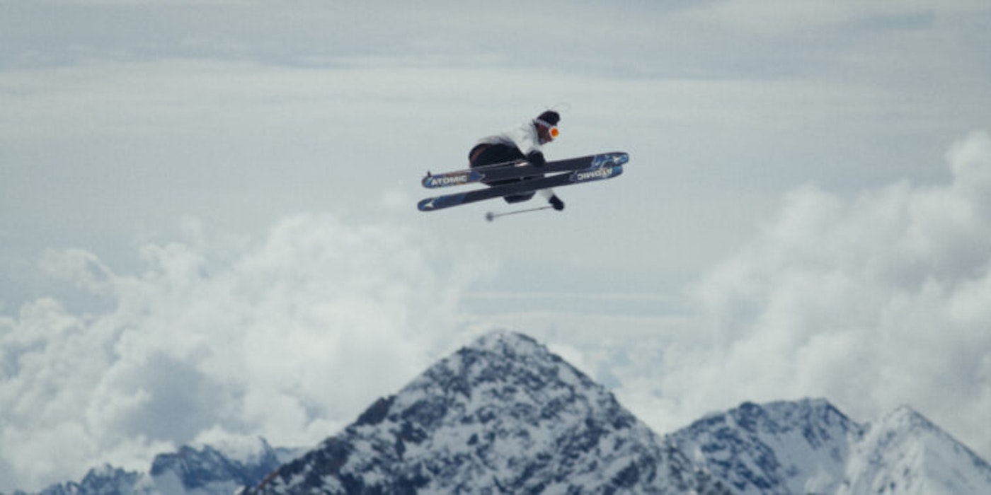 Skier jumps high with skis parallel in the air