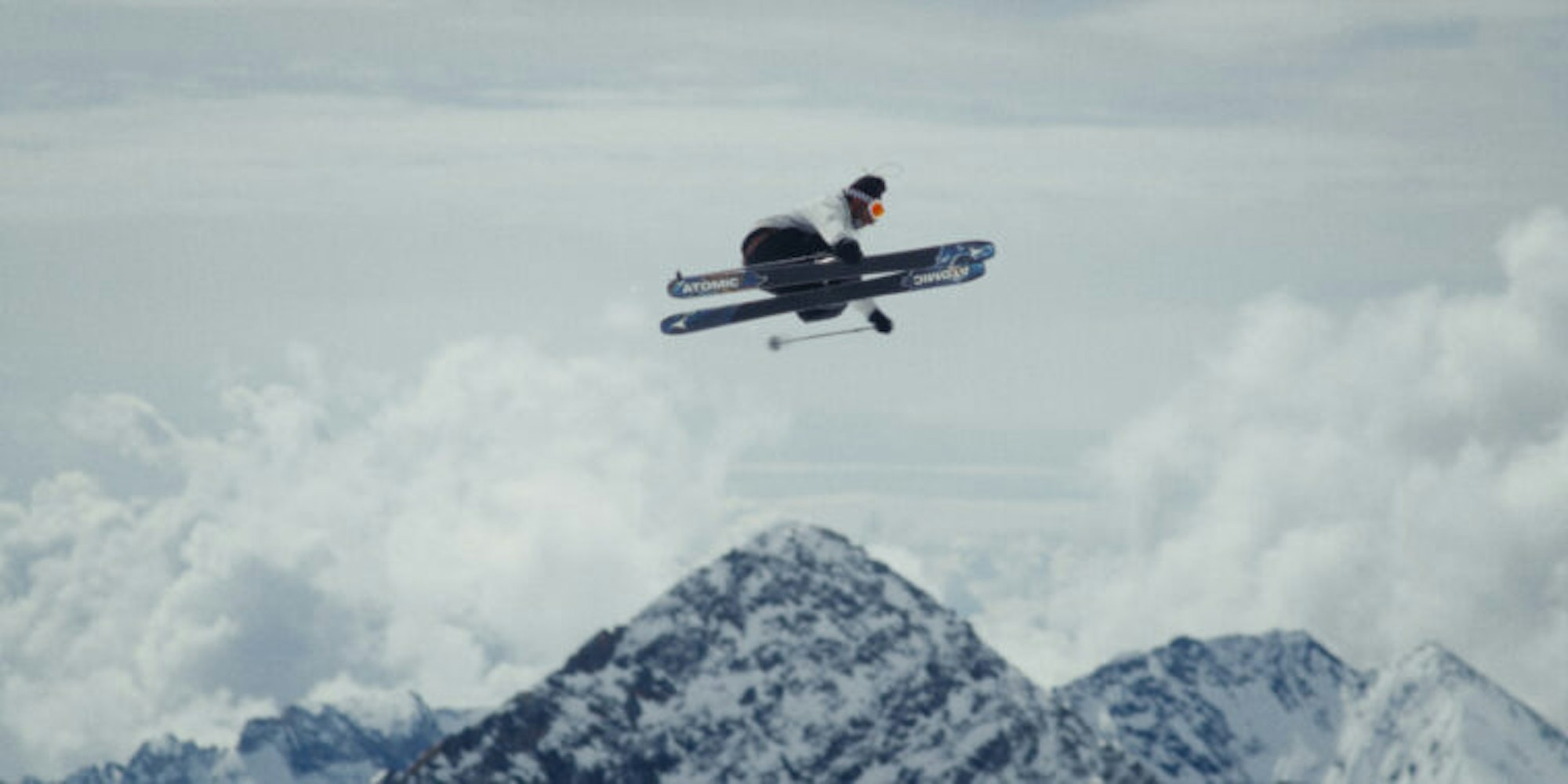 Skier jumps high with skis parallel in the air