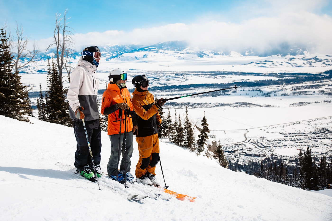 Three skiers on the side of a snow mountain