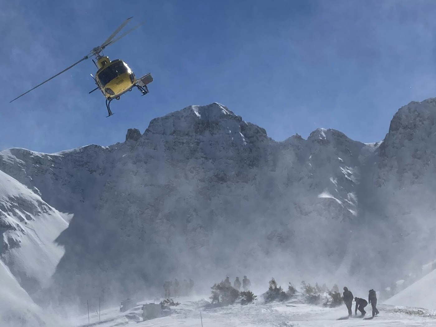 Helicopter veers off a snowy mountain ridge at Silverton Resort in Colorado