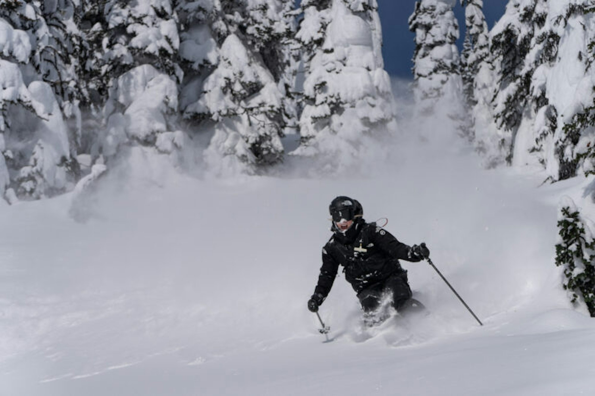Tonje Kvivik skis in deep snow with her mouth open