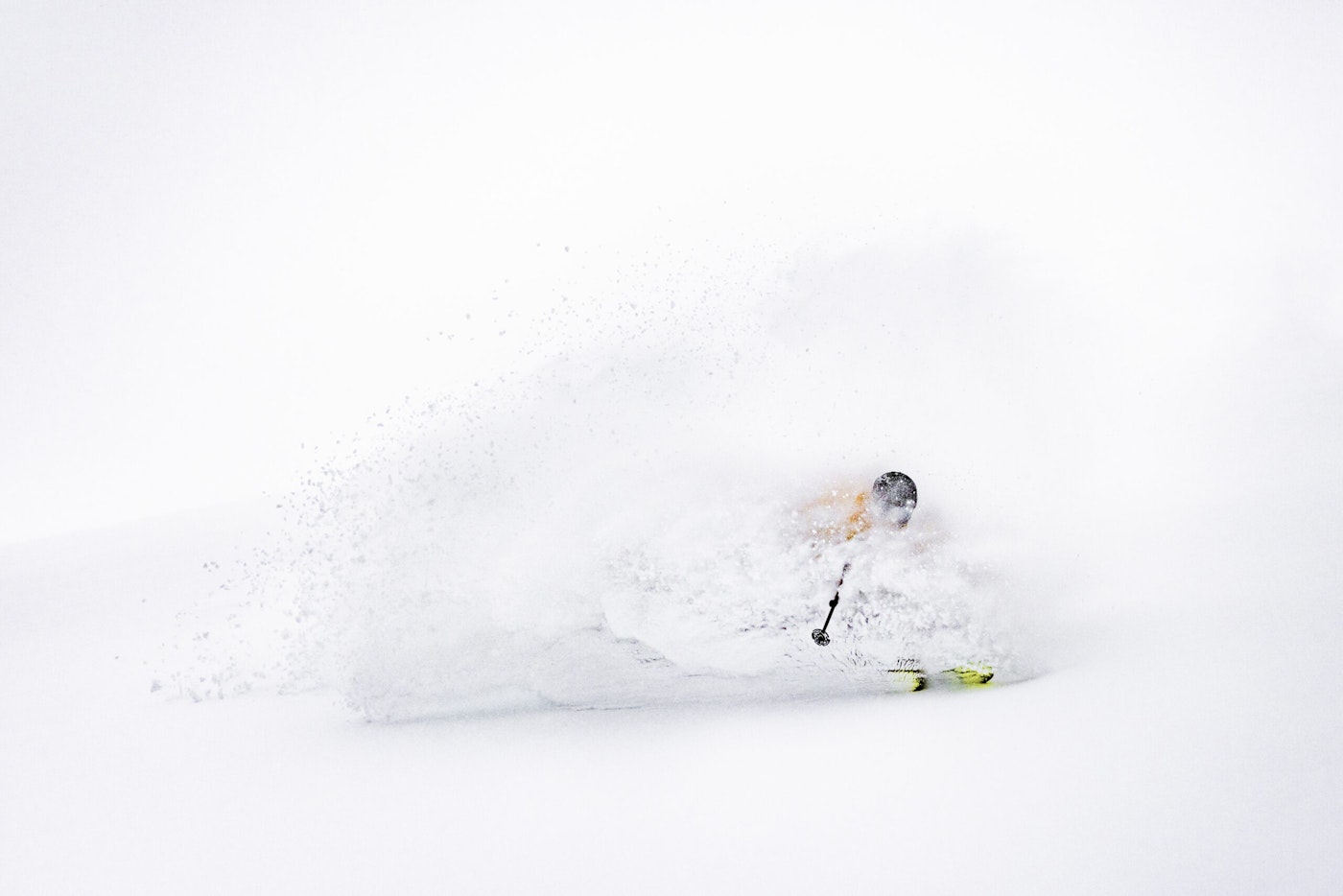 Skier turning through deep powder snow