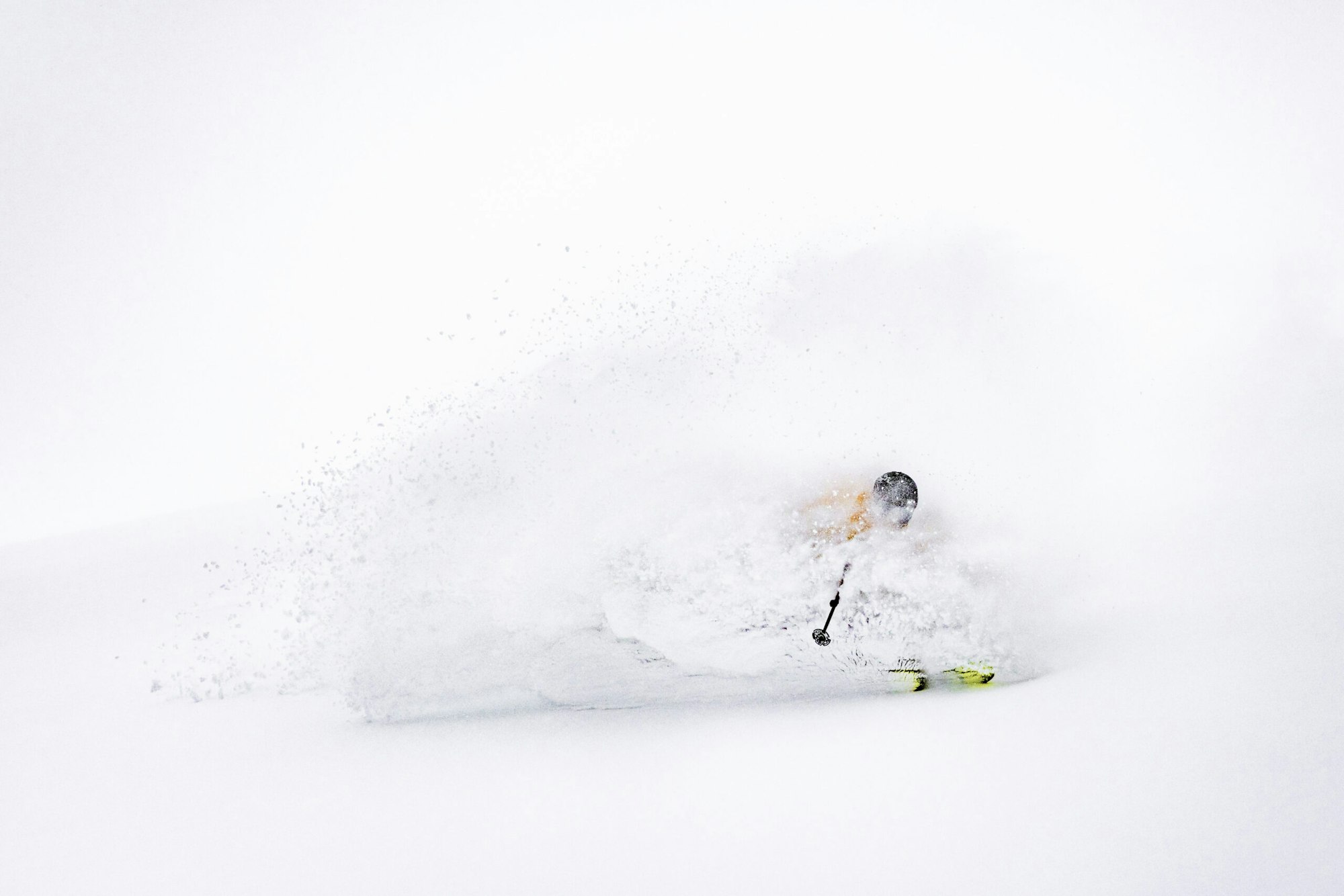 Skier turning through deep powder snow