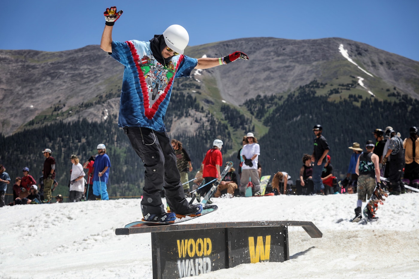 Snowboarder sliding on a rail at Copper Mountain