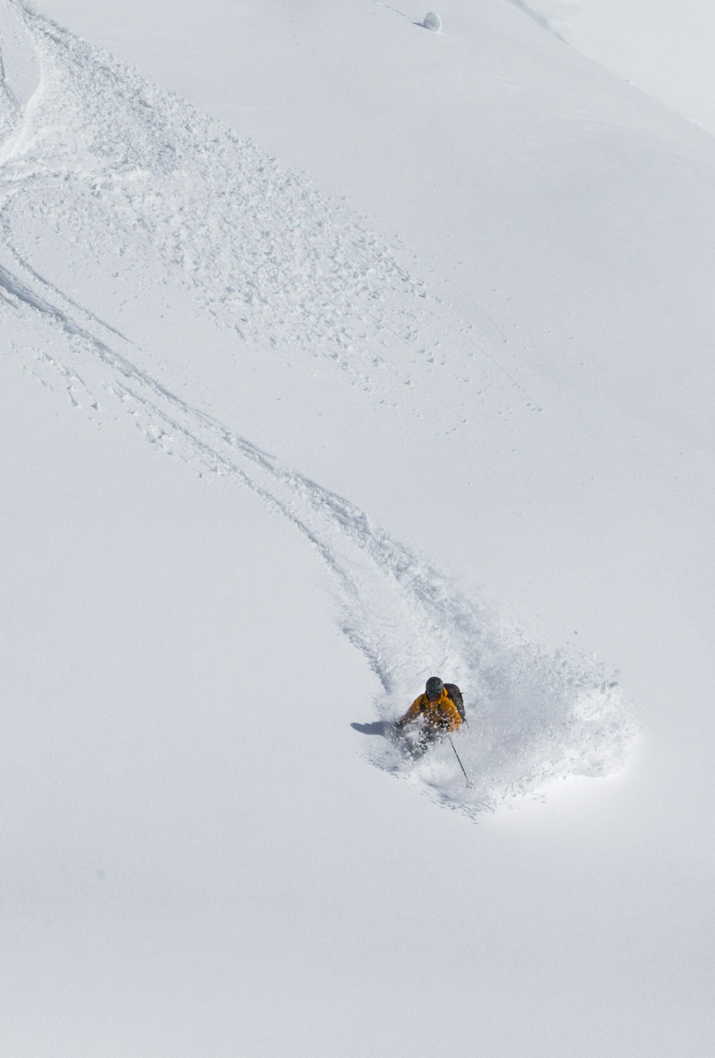 Skier Jaret Bull skiing in deep snow in Stewart, BC