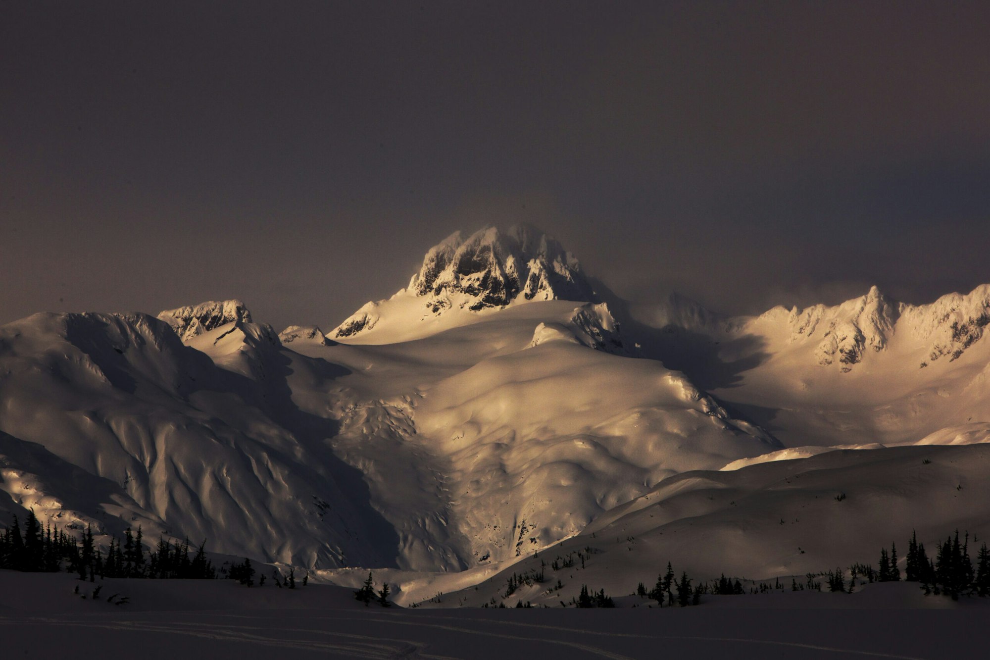Dusk in a snowy mountain range in Northern BC