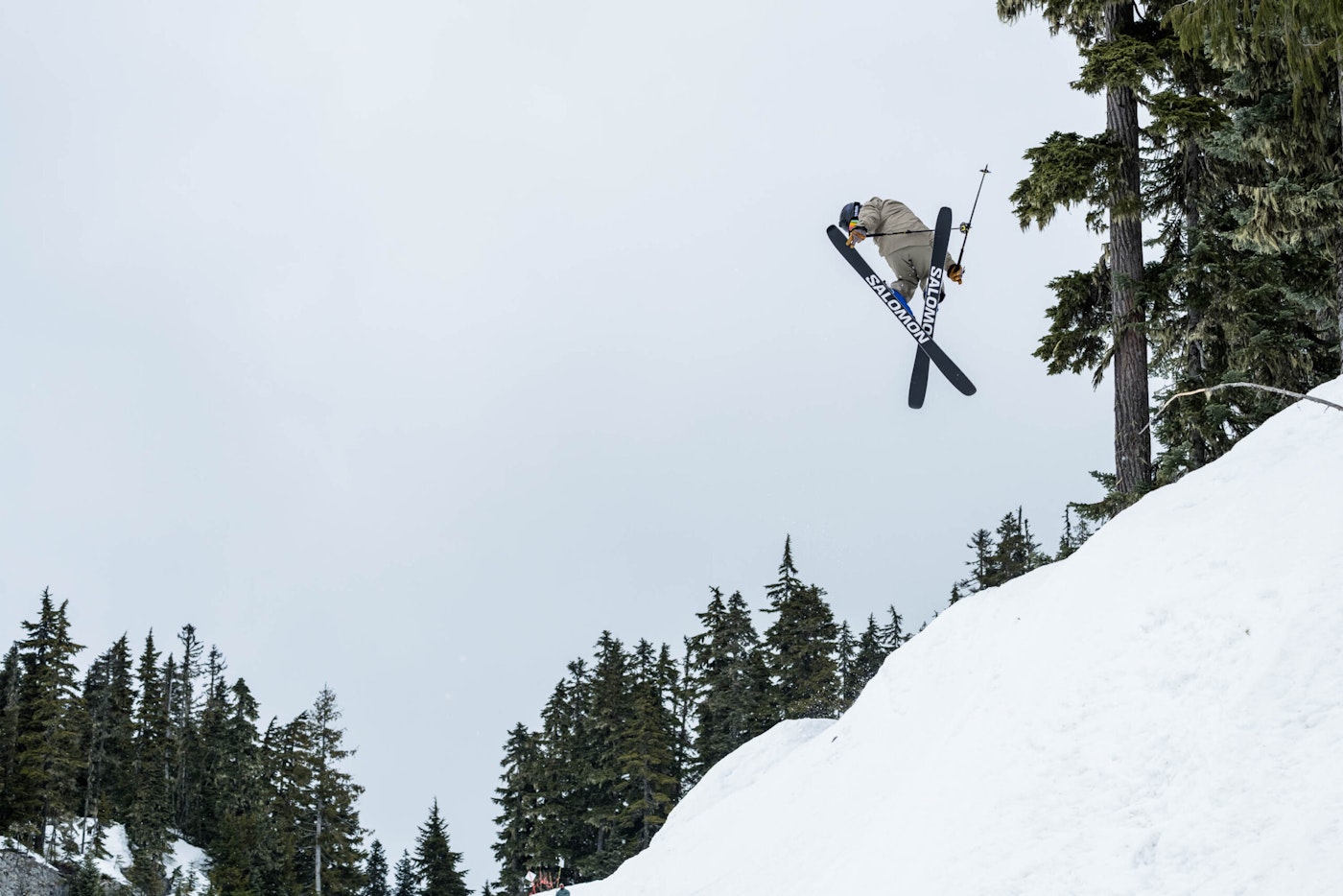 Skier Wyatt Gentry grabbing his skis mid air