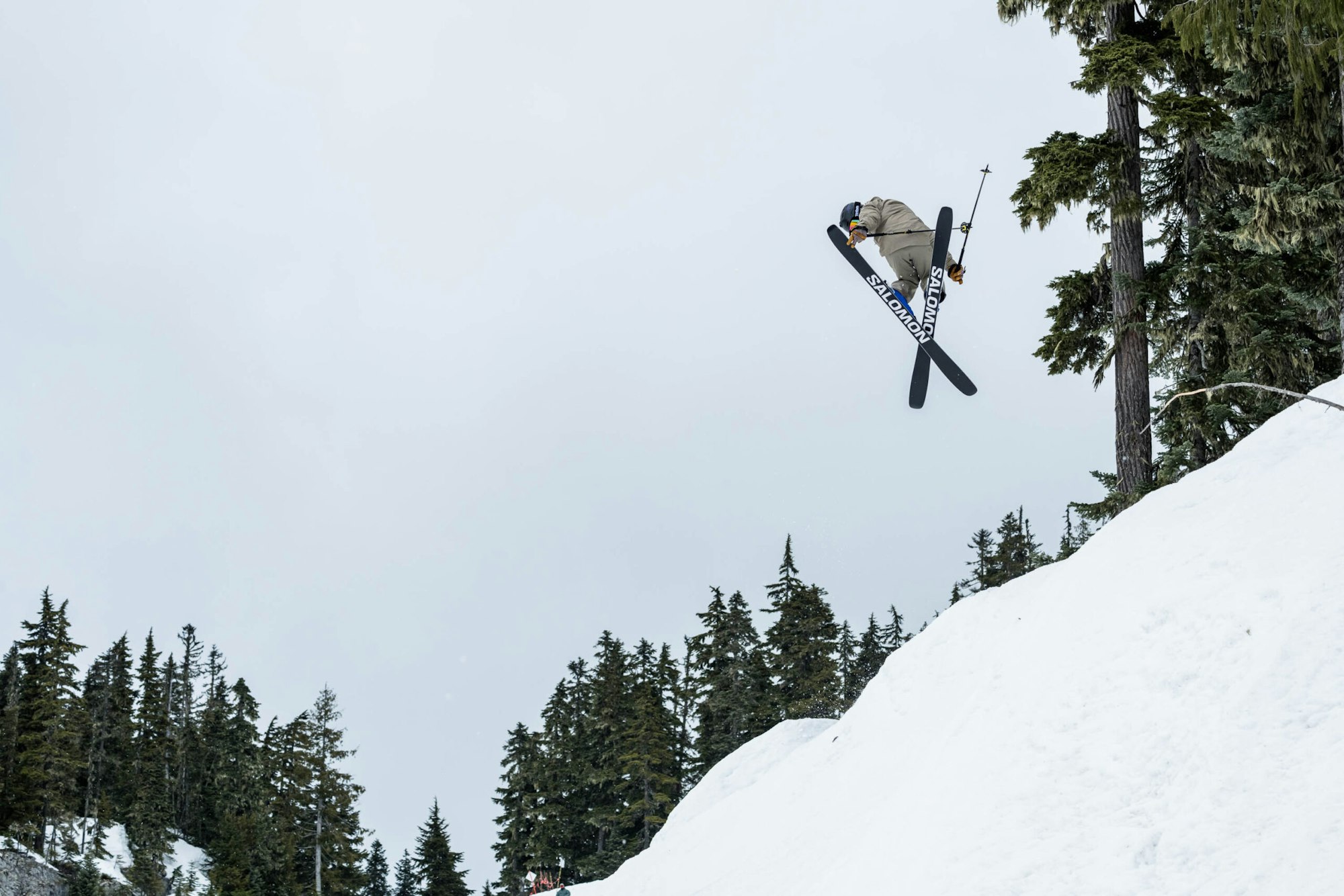 Skier Wyatt Gentry grabbing his skis mid air