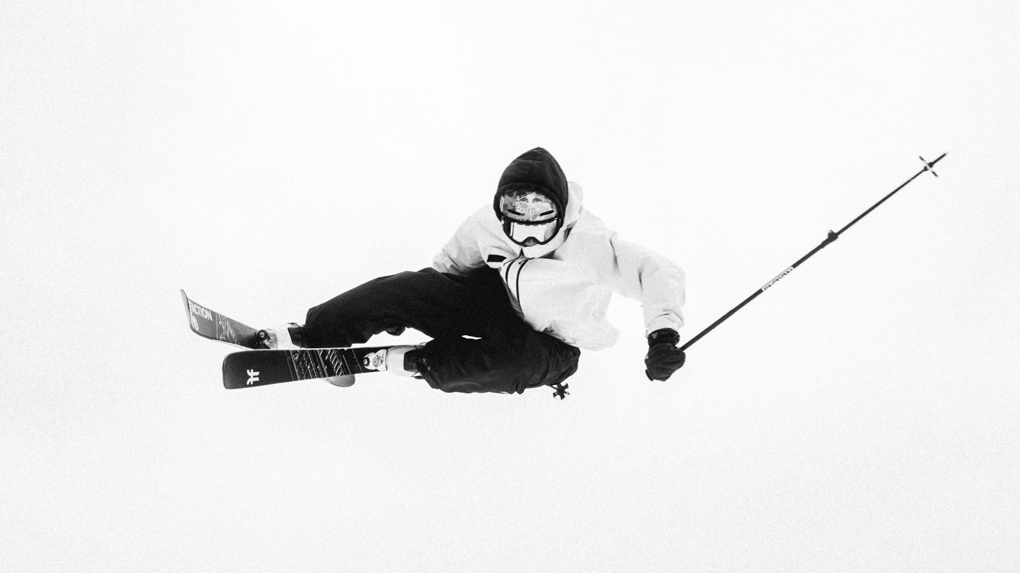 Skier Mac Forehand in the air grabbing his skis